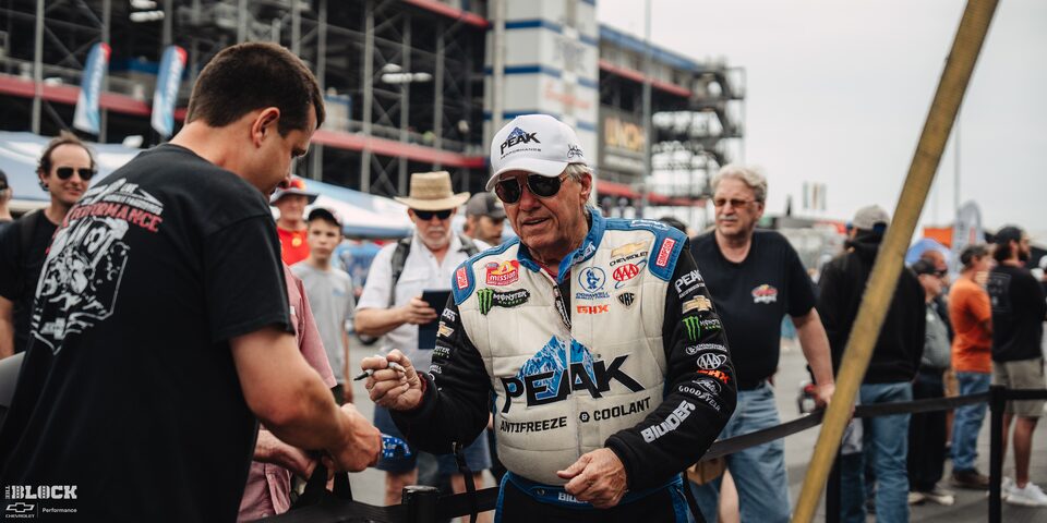 A Race Car Driver Signs an Autograph at Charlotte Motor Speedway