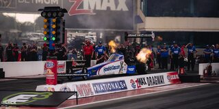 A Top Fuel Dragster Spits Flames on the Track as the Crew Watches at the 2024 NHRA 4-Wide Nationals