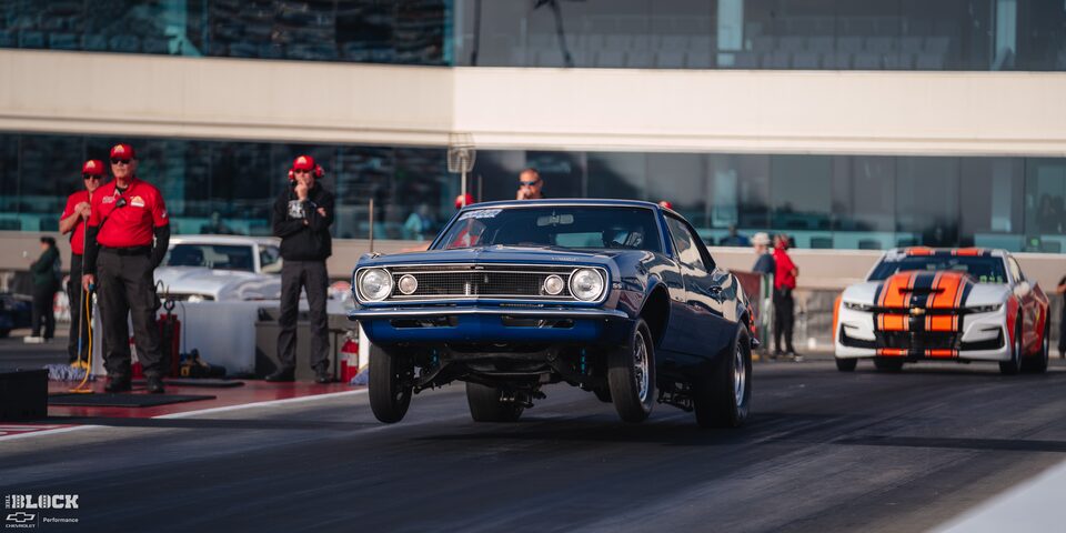 Front View of a Blue Chevrolet Muscle Car With Two Front Wheels off the Track at the 2024 NHRA 4-Wide Nationals