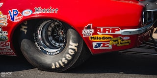 Close-up of the Front Rear Tire Which Reads "Hoosier" for a Red Chevrolet Muscle Car at the 2024 NHRA 4-Wide Nationals