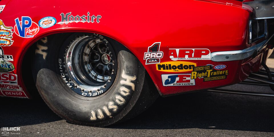 Close-up of the Front Rear Tire Which Reads "Hoosier" for a Red Chevrolet Muscle Car at the 2024 NHRA 4-Wide Nationals