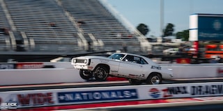 Side View of a White Chevrolet Muscle Car Speeding Down the Track at Charlotte Motor Speedway