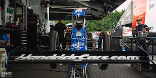 Close-up Front View of a Blue Race Car With Nearby Crew at Charlotte Motor Speedway