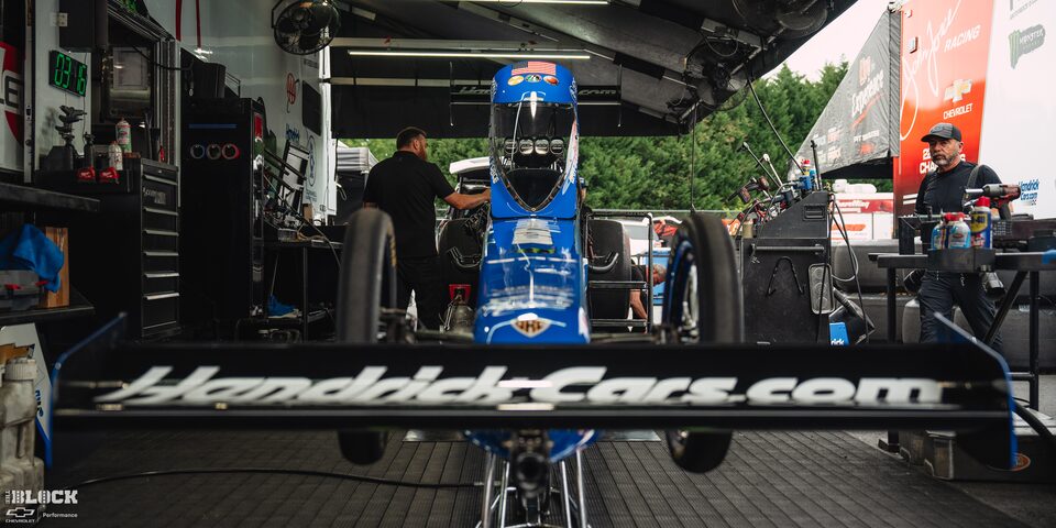 Close-up Front View of a Blue Race Car With Nearby Crew at Charlotte Motor Speedway