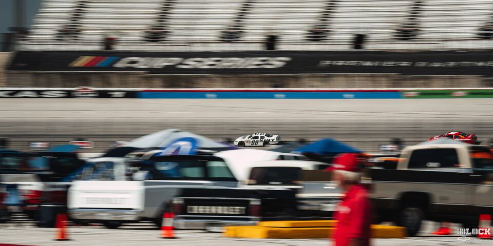 Distant View of a White Chevy Camaro Racing on the Track at Texas Motor Speedway