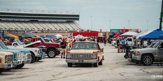 Front View of a Classic Chevrolet Pickup Truck Driving Through a Row of Classic GM Trucks at Texas Motor Speedway