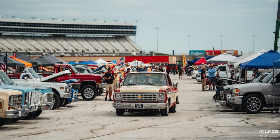 Front View of a Classic Chevrolet Pickup Truck Driving Through a Row of Classic GM Trucks at Texas Motor Speedway