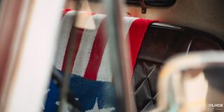 Close-up of an American Flag Draped Over a Leather Seat in a Classic Chevy Pickup Truck