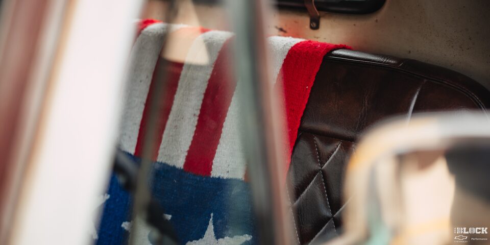 Close-up of an American Flag Draped Over a Leather Seat in a Classic Chevy Pickup Truck