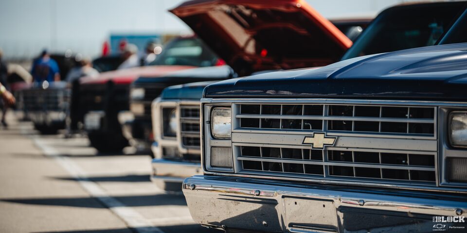 Close-up of a Row of Chevy Pickup Trucks with Open Hoods at the 2024 Texas C10 Nationals