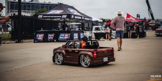 Rear View of a Small Child Driving an Electric Toy Chevy Truck at the 2024 Texas C10 Nationals