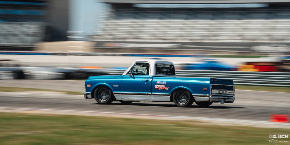Side View of a Bright Blue Classic Chevy Pickup Surging Down the Track at Texas Motor Speedway