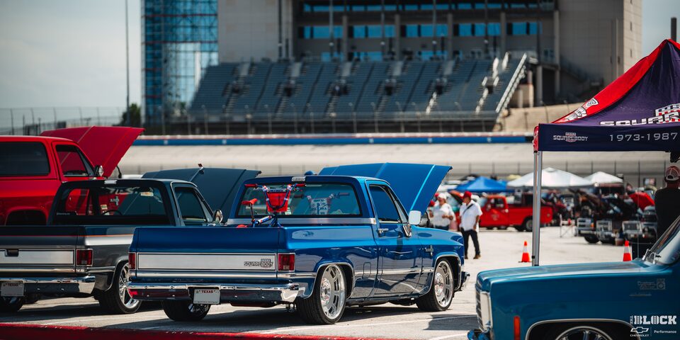 Rear View of a Parked Blue Chevy Superbody Pickup Truck With a Red Bicycle in the Truck Bed at Texas Motor Speedway