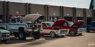 Lineup of Parked Classic Chevy Trucks With Open Hoods at Texas Motor Speedway