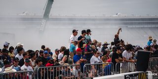 An Excited Crowd Watches Races at the 2024 Texas C10 Nationals With Smoke Billowing in the Backgrouund
