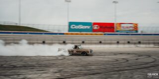 A Brown Classic Chevy Pickup Truck Burns Rubber at Texas Motor Speedway