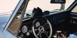 Interior of a Vintage Chevrolet Truck With a Black Cowboy Hat Placed on the Steering Wheel