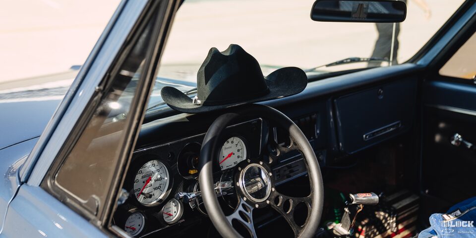 Interior of a Vintage Chevrolet Truck With a Black Cowboy Hat Placed on the Steering Wheel 