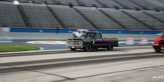 Lineup of Parked Classic Chevy Trucks With Open Hoods at Texas Motor Speedway