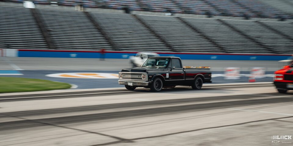 A Classic Chevy Pickup Truck Speeds Down the Track at Texas Motor Speedway