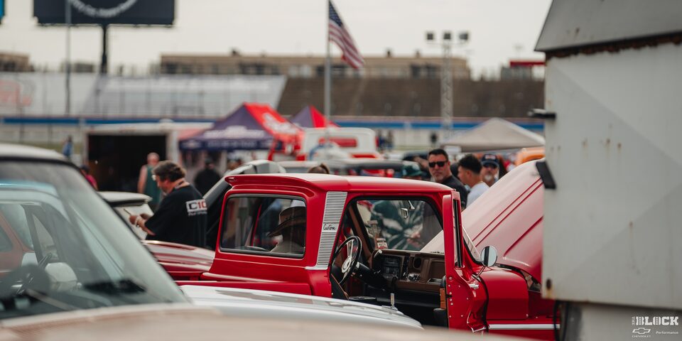 Rear View of a Parked Classic Red Chevrolet Pickup Truck With an Open Hood at the 2024 Texas C10 Nationals
