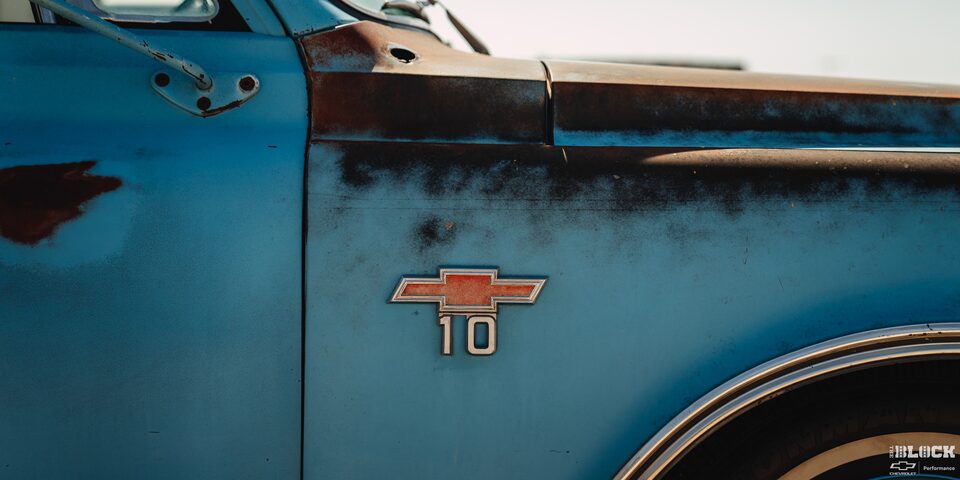 Close-up of the Right Front of a Blue Classic Chevy With the Chevrolet Ornament Over a "10" Decal