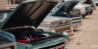 A Line of Classic Chevy Trucks With Open Hoods at the 2024 Texas C10 Nationals