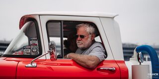 Close-up of the Driver of a Chevrolet C10 Pickup Truck With His Arm Resting Outside the Vehicle's Window 