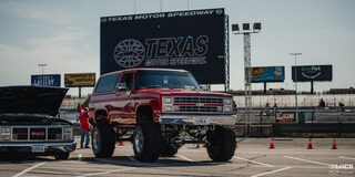 A Gigantic Red Chevy Pickup Truck Parked at Texas Motor Speedway