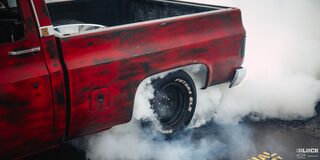 Side View of Cherry Red Chevy Pickup Truck Burning Rubber at 2024 Texas C10 Nationals