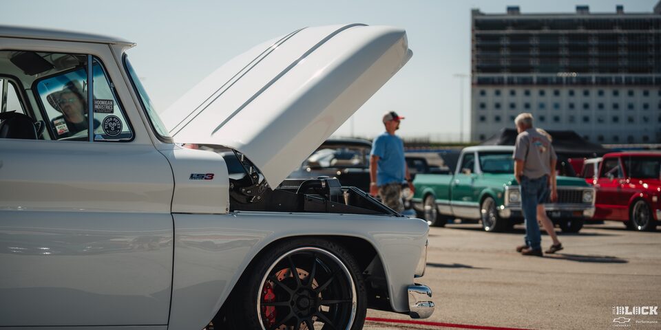 Side View of Vintage White Chevy Pickup Truck With an Open Hood at Texas Motor Speedway