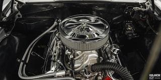 Overhead View of a Silver Air Filter Sitting on Top of an Engine Shining in the Vehicle