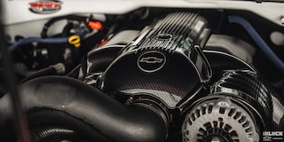Close-up of Engine with a Chevy Emblem on It with Light Being Reflected from the Top