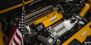 Close-up of a Yellow Engine with with the American Flag in Front