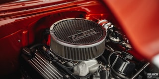 Close-up of an Air Filter on Top of an Engine inside an Orange Vehicle
