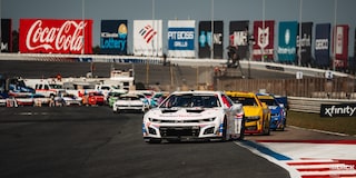 Front View of Line of Racecars with a White Chevy Racecar Leading the Pack