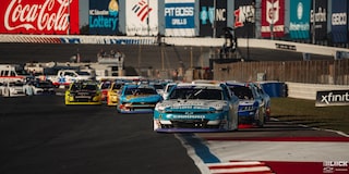 Front View of a Car Race with a Blue Chevy Racecar Leading the Charge