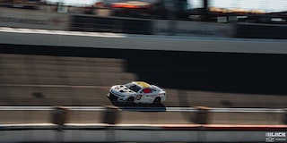 Overhead View of a White Custom Racecar Speeding Down the Track on a Sunny Day