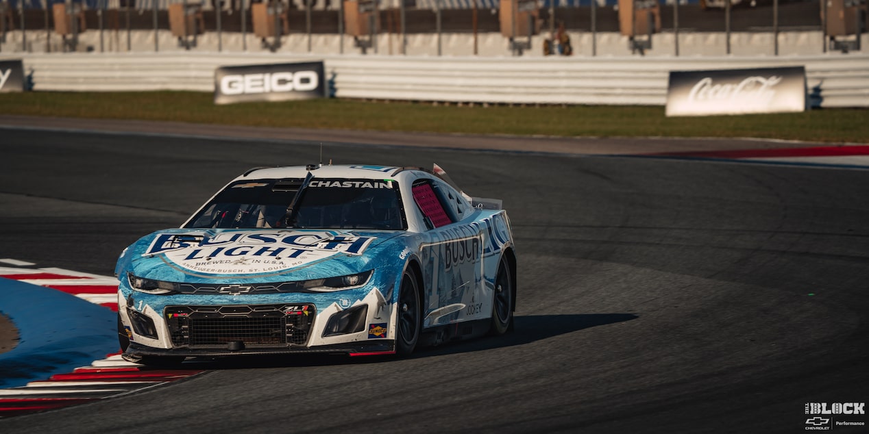 Three Quarters View of a Custom Chevy Racecar Driving Down the Racetrack