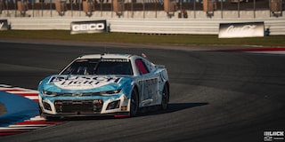 Three Quarters View of a Custom Chevy Racecar Driving Down the Racetrack