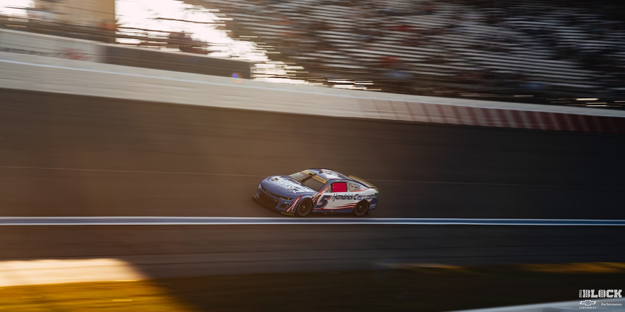 Overhead View of a Blue Custom Racecar Speeding Down the Track in the Afternoon