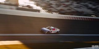 Overhead View of a Blue Custom Racecar Speeding Down the Track in the Afternoon