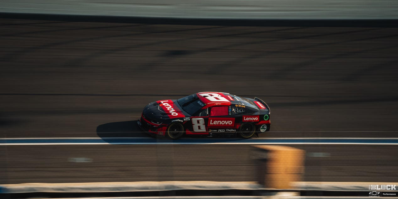 Overhead Side View of a Custom Racecar Speeding Down the Racetrack in the Afternoon
