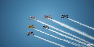 Six Airplanes Leaving Contrails Side by Side on a Bright Blue Sky
