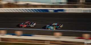 Overhead View of Two Custom Racecars Speeding Down the Track
