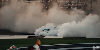Smoke Covering the Whole Racetrack with the Barely Visible Rear of a Racecar in the Middle of It