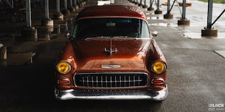 View of the Front of an Orange 1955 Chevy Handyman Wagon Parked Under Cover from the Rain
