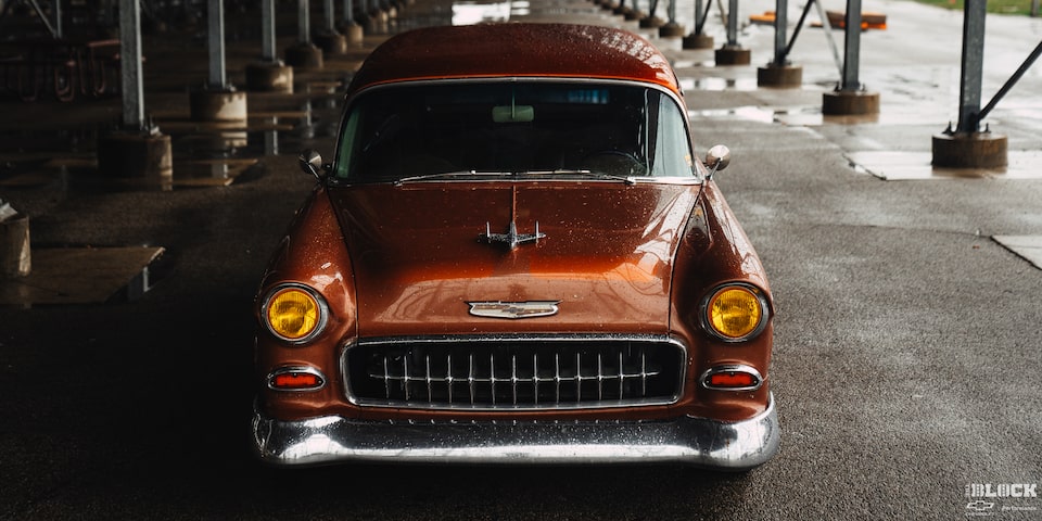 View of the Front of an Orange 1955 Chevy Handyman Wagon Parked Under Cover from the Rain