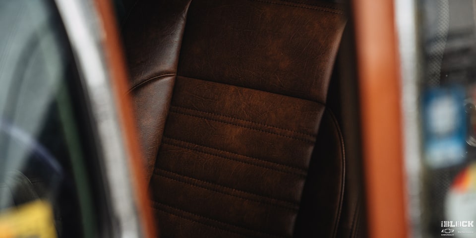 Close-up of the Driver's Seat of a 1955 Chevy Handyman Wagon Viewed Outside through the Window