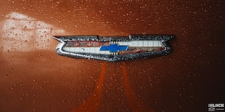 Close-up of the Chevrolet Emblem on an Orange 1955 Handyman Wagon